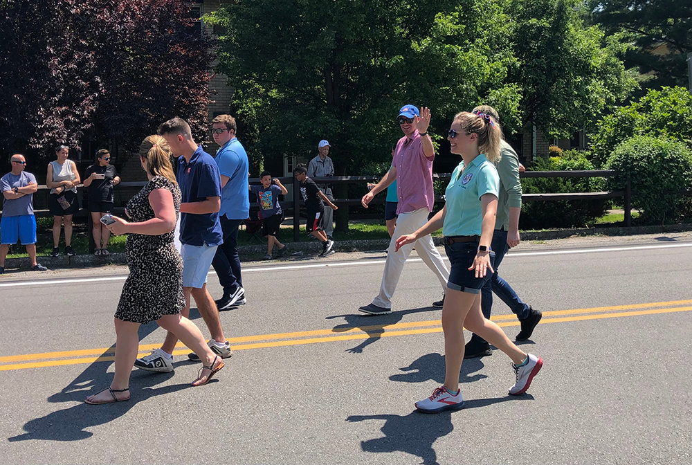 Assemblyman Colin Schmitt [pink shirt] waves to the crowd and was joined by his staff in marching in the parade.